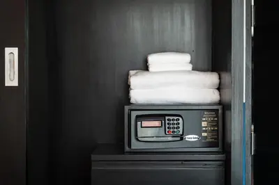 a pile of towels sitting on top of a tv at Blu Monkey Boutique Naiharn - Serviced Apartments 1 Bedroom in Rawai Beach