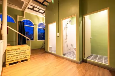 a bathroom with a shower and two mirrors at Queen On Street 2009 in Ban Lo Long