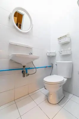 a bathroom with a white toilet and a sink at Queen On Street 2009 in Ban Lo Long