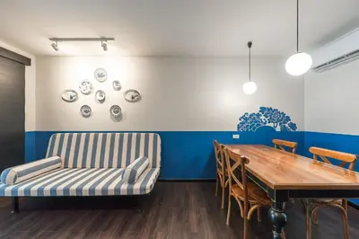 a dining room with a bench and a table at Blu Monkey Boutique Naiharn - Serviced Apartments 2 Bedrooms in Rawai Beach