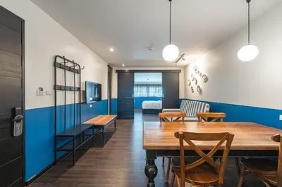 a dining room with a table and chairs at Blu Monkey Boutique Naiharn - Serviced Apartments 2 Bedrooms in Rawai Beach
