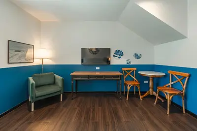 a room with a desk and two chairs at Blu Monkey Boutique Naiharn - Serviced Apartments 2 Bedrooms in Rawai Beach
