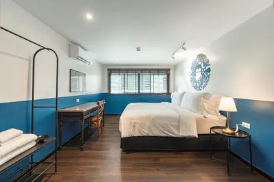 a bedroom with a bed and a desk in it at Blu Monkey Boutique Naiharn - Serviced Apartments 2 Bedrooms in Rawai Beach
