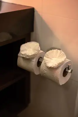 two rolls of toilet paper on a wall in a bathroom at The Beach Residence Kata in Kata Beach