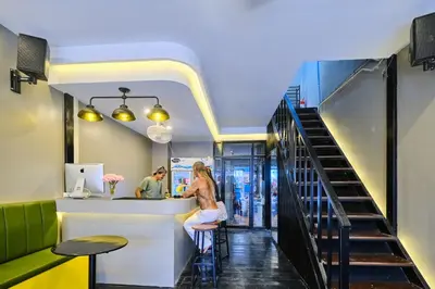 a woman sitting at a bar in a restaurant at Friendz Hostel in Phi Phi Don