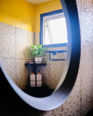 a view of a bathroom with a window and a plant at Friendz Hostel in Phi Phi Don