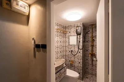 a bathroom with a toilet and a sink at RQ Timeless Phuket Old Town in Phuket Town