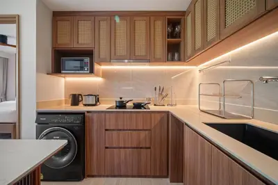 a kitchen with a washer and dryer in it at Laguna Beach Residences Seashore by Banyan Living in Thalang