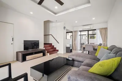 a living room with a couch and a fireplace at Laguna Parkside Residences by Banyan Living in Phuket Town