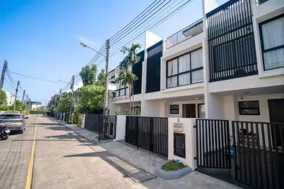 a building with a fence on the side of a street at Laguna Parkside Residences by Banyan Living in Phuket Town