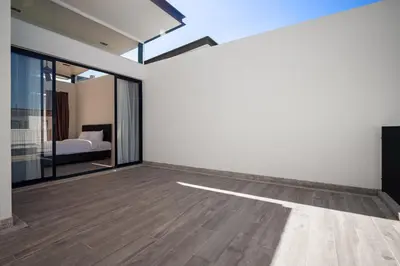 an empty room with a bed and a window at Laguna Parkside Residences by Banyan Living in Phuket Town