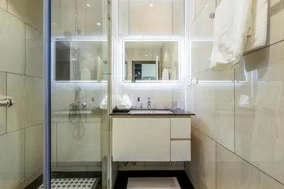 a white bathroom with a sink and a shower at Tropical studio Luxury Amenities and Pool in Bang Tao Beach