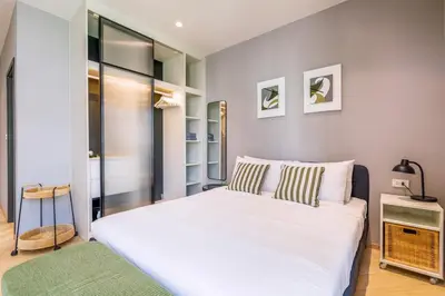 a bedroom with a large white bed in a room at Tropical studio Luxury Amenities and Pool in Bang Tao Beach