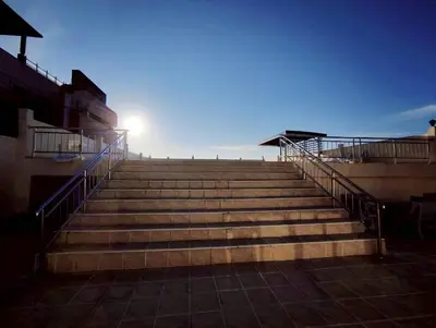 a set of stairs with the sun in the background at 3-bedroom apartment, Patong, Palm Spring 602 in Patong Beach
