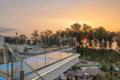 a view of a swimming pool from a building at Elegant Beachside Retreat Modern Stay Pool Bar in Layan Beach