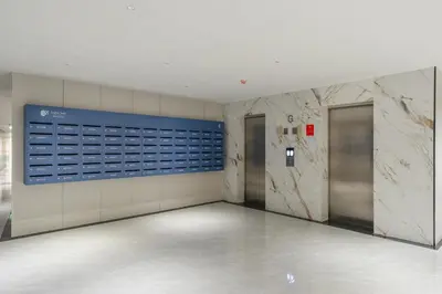 an empty hallway with two elevators in a building at Elegant Beachside Retreat Modern Stay Pool Bar in Layan Beach