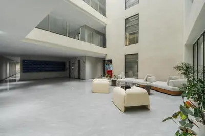 a lobby with couches and chairs in a building at Elegant Beachside Retreat Modern Stay Pool Bar in Layan Beach
