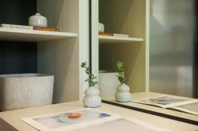 a table with two white vases on a table with a mirror at Bangtao The Title Legendary by Phuket Sabay Rent C108 in Bang Tao Beach