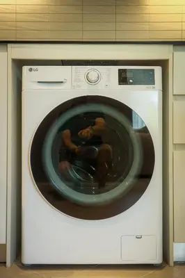a baby is sitting inside of a washing machine at Bangtao The Title Legendary by Phuket Sabay Rent C108 in Bang Tao Beach
