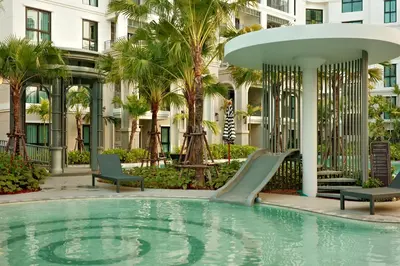 a swimming pool with a slide in front of a building at Bangtao The Title Legendary by Phuket Sabay Rent D204 in Bang Tao Beach
