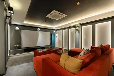 a living room with a red couch and a flat screen tv at Bangtao The Title Legendary by Phuket Sabay Rent D204 in Bang Tao Beach