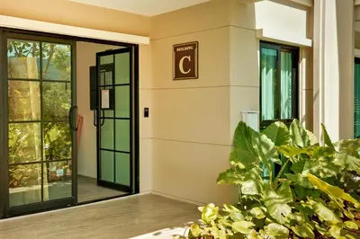 a lobby with a door and some plants at Bangtao The Title Legendary by Phuket Sabay Rent D204 in Bang Tao Beach