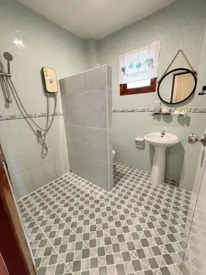 a bathroom with a shower and a sink at Sachi Home Bangtao -Private House Near Beach in Ban Thalat Choeng Thale