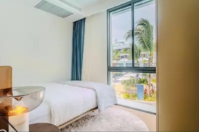 a bedroom with a bed and a large window at Two Bedroom Sea View by Triple 8 Asia in Layan Beach