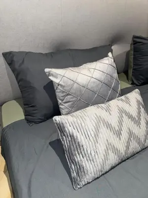 a couch with four pillows on top of it at Title Legendary in Phuket