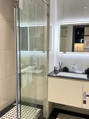 a bathroom with a glass shower and a sink at Title Legendary in Phuket