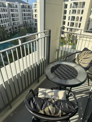 a table and chairs on a balcony with a view of buildings at Title Legendary in Phuket