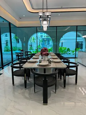 a dining room with a large table and chairs at Title Legendary in Phuket