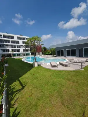 a large yard with a pool and a building at Babylon Sky Garden 2 in Rawai Beach