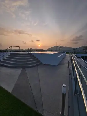 a sunset on the roof of a building with stairs at Babylon Sky Garden 2 in Rawai Beach