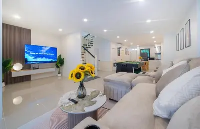 a living room with a couch and a tv at Patong Center lucky home in Patong Beach