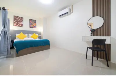 a bedroom with a bed and a desk and a chair at Patong Center lucky home in Patong Beach