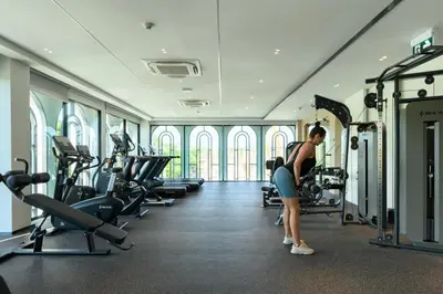 a woman is working out in a gym at Bangtao The Title Legendary by Phuket Sabay Rent F501 in Bang Tao Beach