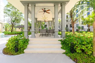 a gazebo with a table and chairs and flowers at Bangtao The Title Legendary by Phuket Sabay Rent F501 in Bang Tao Beach