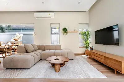 a living room with a couch and a flat screen tv at Baan Araya by Villacarte in Ban Saiyuan (1)