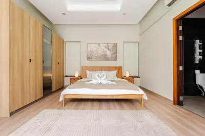 a bedroom with a bed with a flower on it at Baan Araya by Villacarte in Ban Saiyuan (1)