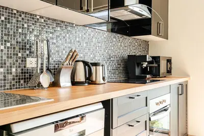 a kitchen with a wooden counter top with a sink at Baan Araya by Villacarte in Ban Saiyuan (1)