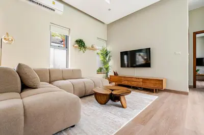 a living room with a couch and a table at Baan Araya by Villacarte in Ban Saiyuan (1)