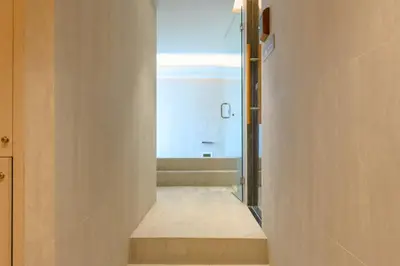 a hallway leading to a bathroom with a bath tub at Bangtao The Title Legendary by Phuket Sabay Rent F201 in Bang Tao Beach