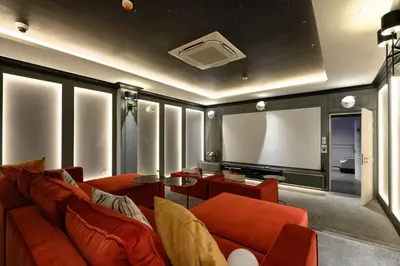a living room with a couch and a projection screen at Bangtao The Title Legendary by Phuket Sabay Rent A212 in Bang Tao Beach