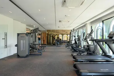 a gym with rows of treadmills and ellipticals at Bangtao The Title Legendary by Phuket Sabay Rent A212 in Bang Tao Beach