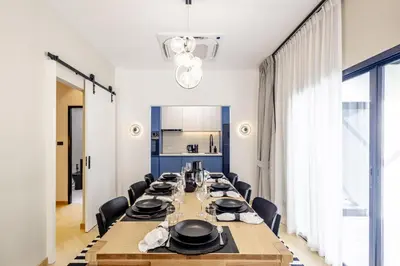 a long dining room with a long table and chairs at 5BR Luxury Pool Villa Patong TPSV138 in Patong Beach