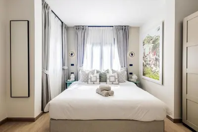 a bedroom with a large white bed in front of a window at 5BR Luxury Pool Villa Patong TPSV138 in Patong Beach
