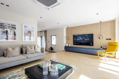 a living room with a couch and a tv at 5BR Luxury Pool Villa Patong TPSV138 in Patong Beach