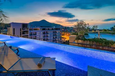a hotel swimming pool with a view of a city at 2 BR Apt Pool View - CTG B507-8 in Kamala Beach