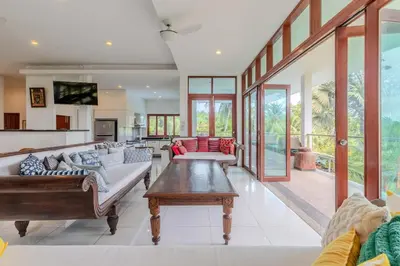 a living room with a couch and a table at V89 6BR Timeless Design Huge Pool & Mountain View in Rawai Beach